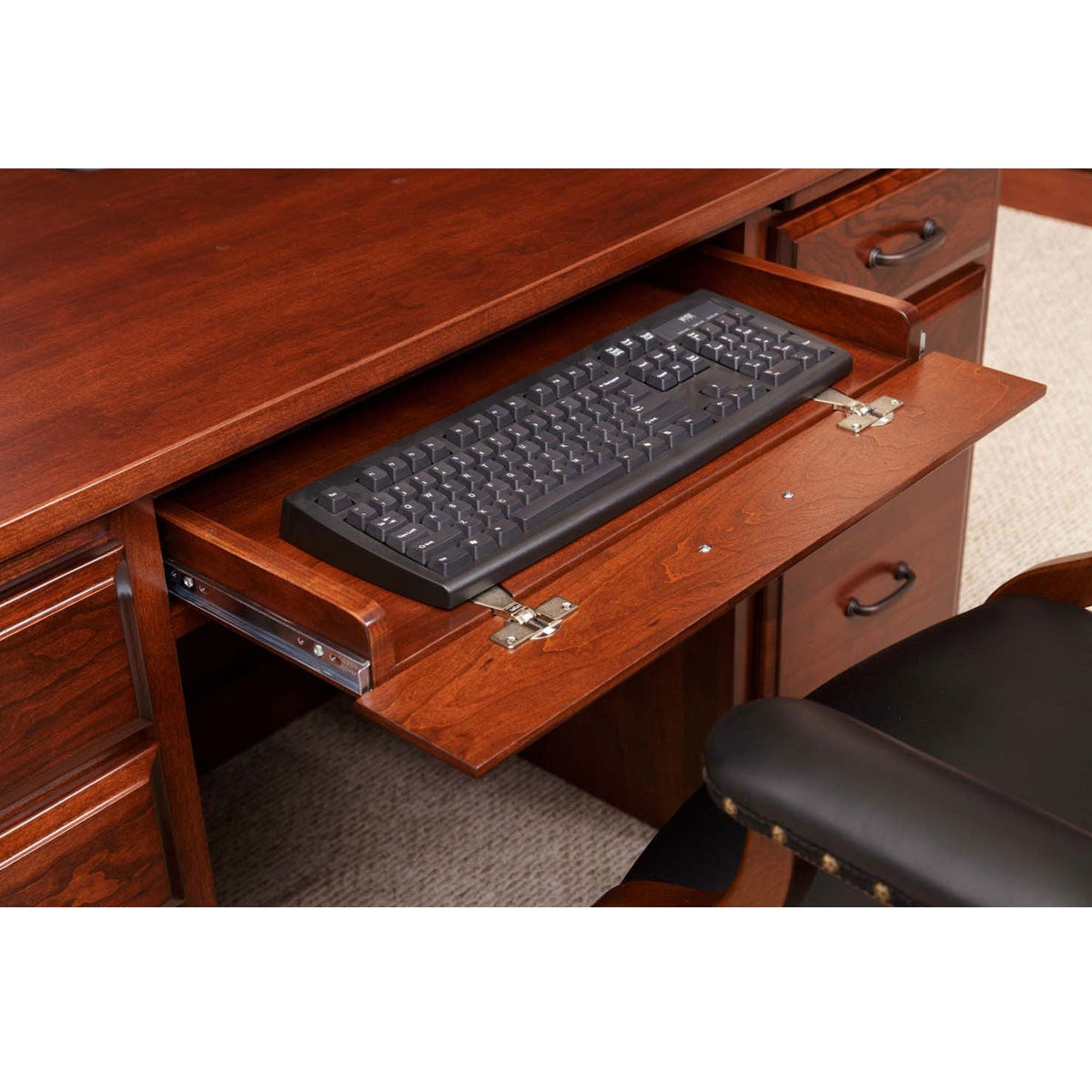 Pull-out keyboard tray extended from beneath the cherry desk top, holding a black keyboard on soft-close slides