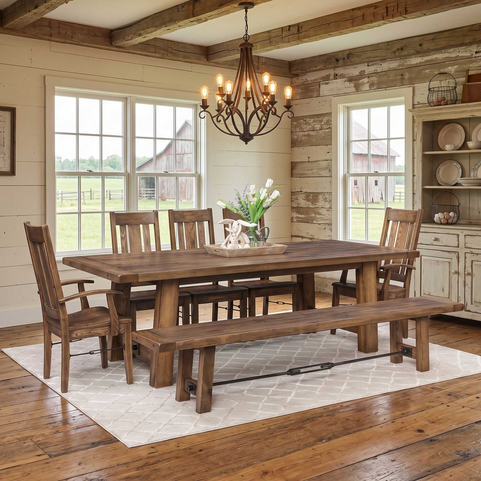 Gray Ouray iron buckle trestle table with plank top and bench, slat back chairs and cotton stems in a dining room