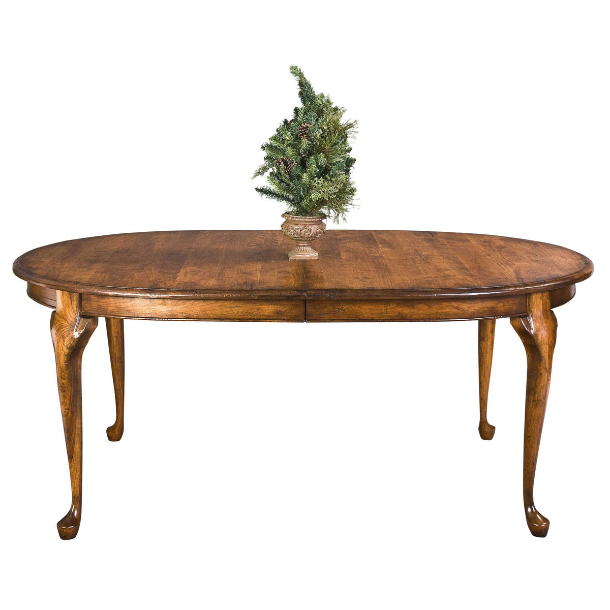 Oval expandable dining table in a warm oak finish with cabriole Queen Anne legs and a center leaf seam