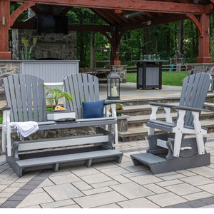 Gray and white poly counter height Adirondack glider bench and swivel glider chair on a patio near a pavilion