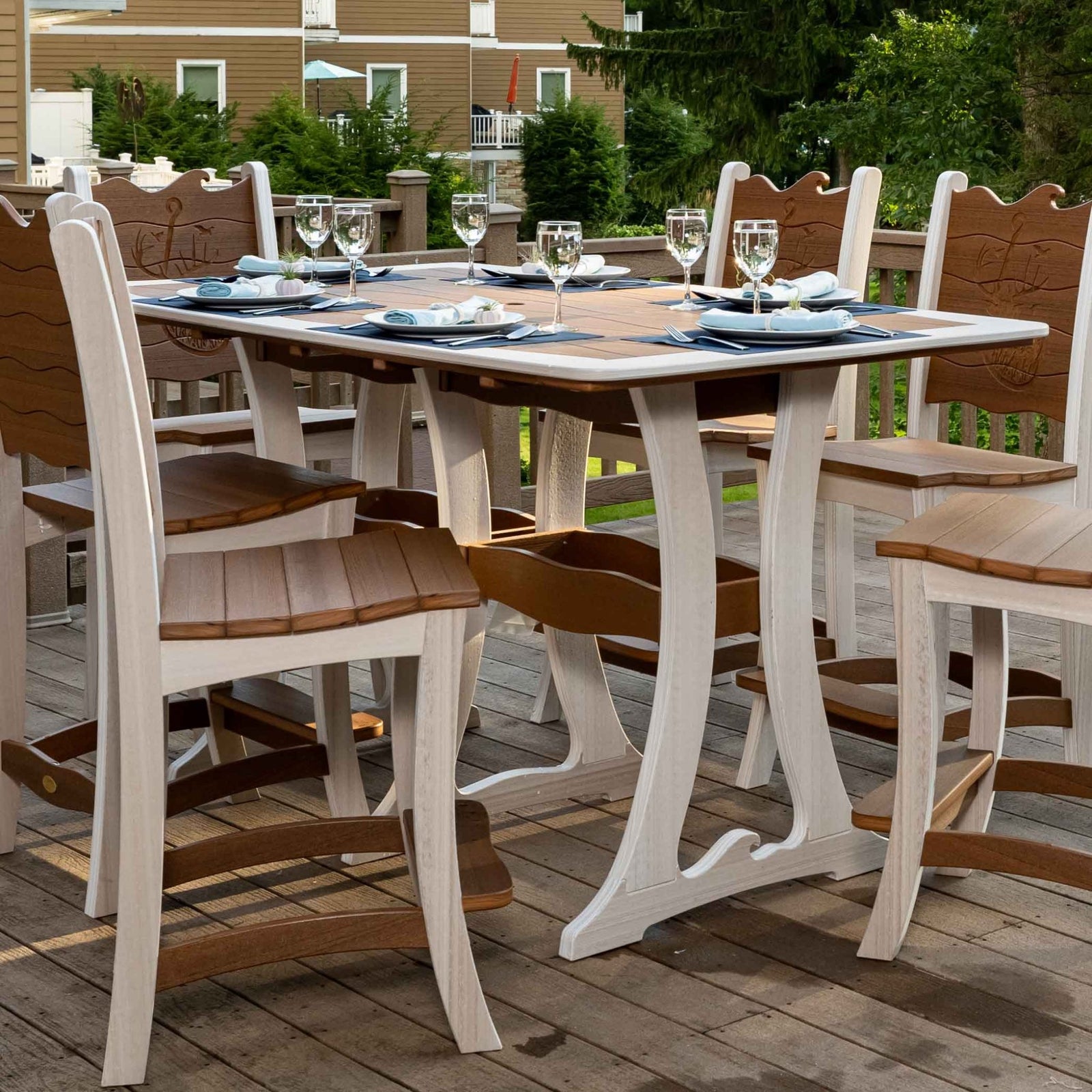 Antique mahogany and white poly bar table with wave edge top and six tall wave back bar chairs on a deck