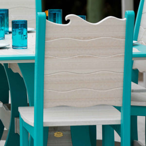 Rear view of a wave back counter chair in driftwood and aruba blue beside a set table with blue glasses