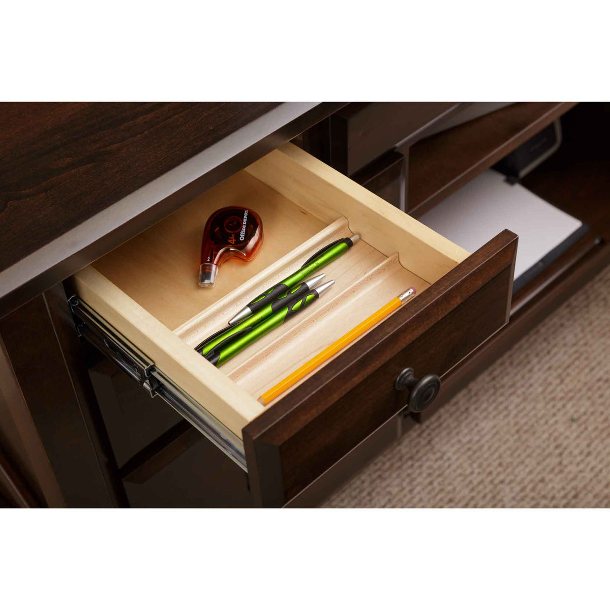 Small pencil drawer opened on the credenza, showing a maple tray with pens, a pencil and tape dispenser