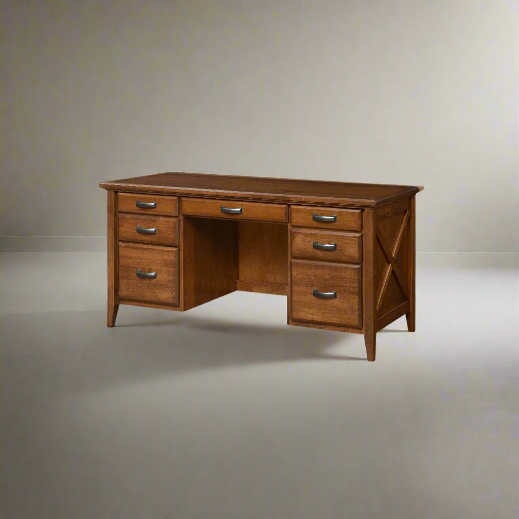 Keyhole double pedestal writing desk in medium oak with six drawers and X panel ends, on a soft gray backdrop