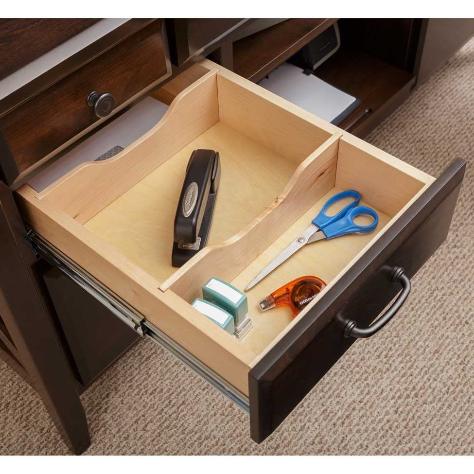 Open desk drawer with maple organizer dividers holding a stapler, scissors, tape and an eraser