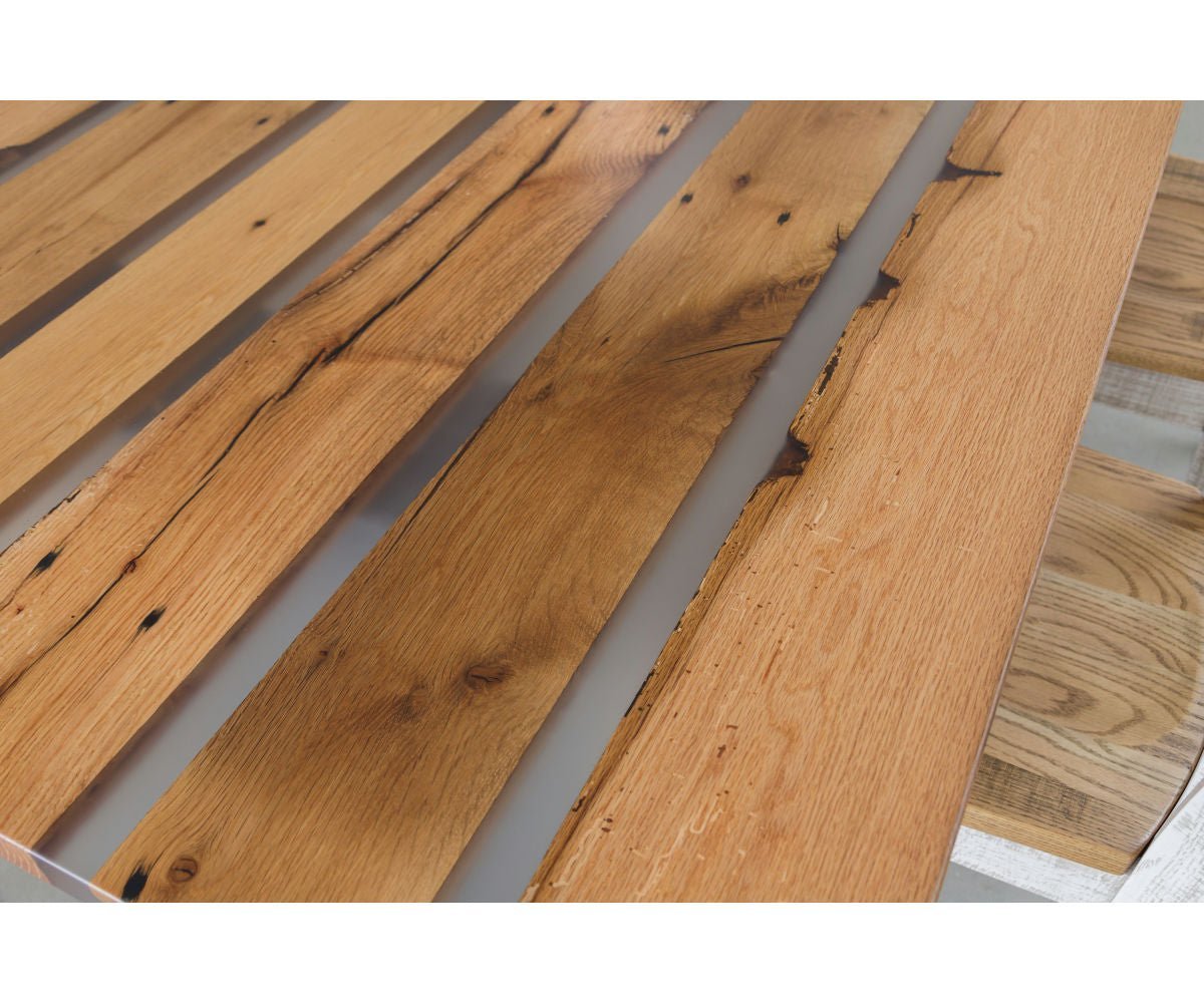 Reclaimed plank and resin dining top viewed lengthwise showing five gray resin rivers between oak boards