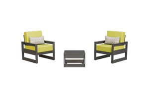 Two gray poly club chairs with yellow-green cushions and patterned pillows beside a low side table