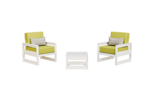 White poly club chairs with chartreuse cushions and patterned pillows on either side of a side table