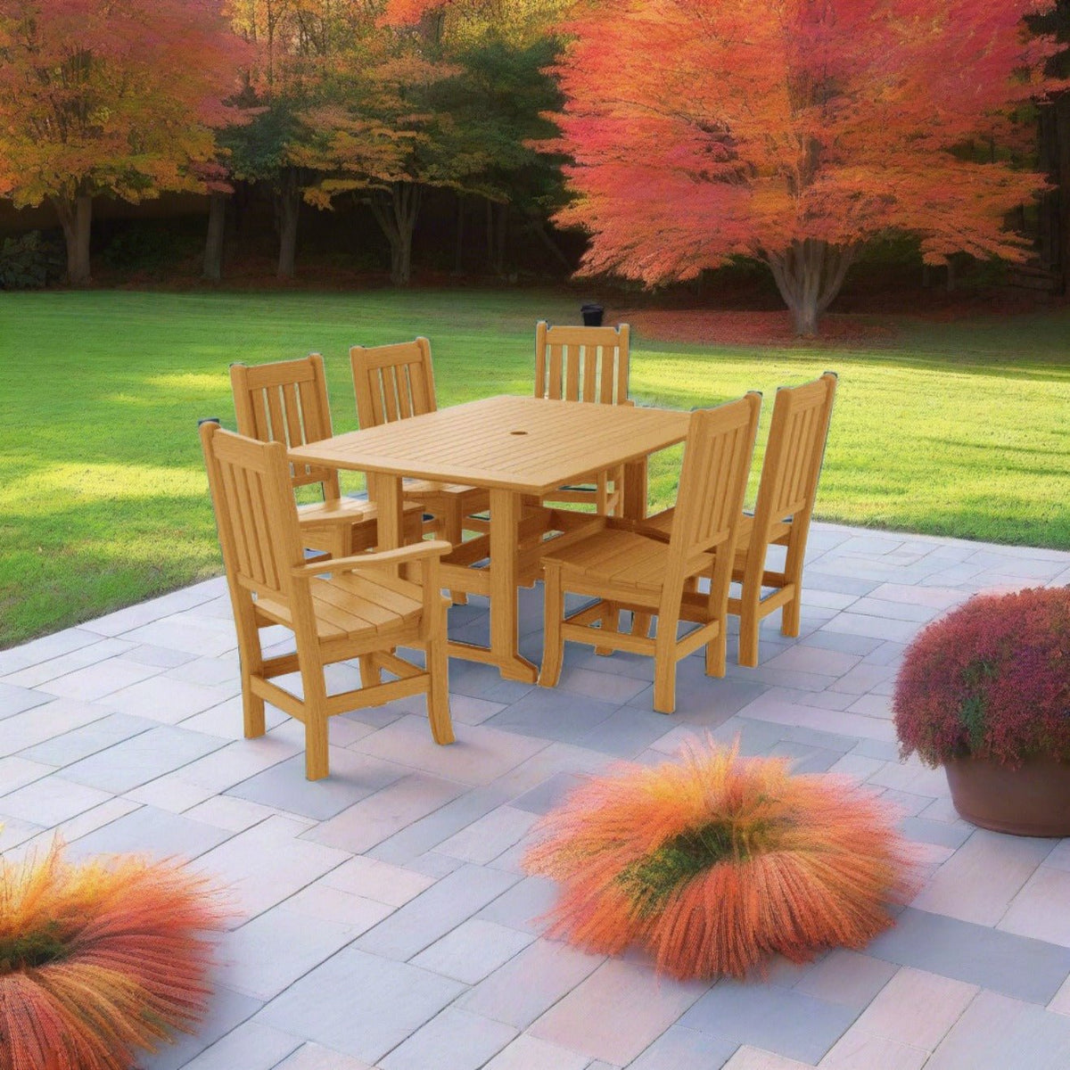 Teak poly dining set for six on a bluestone patio surrounded by autumn maples and ornamental grasses