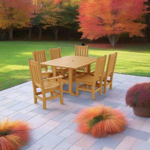 Teak poly dining set for six on a bluestone patio surrounded by autumn maples and ornamental grasses