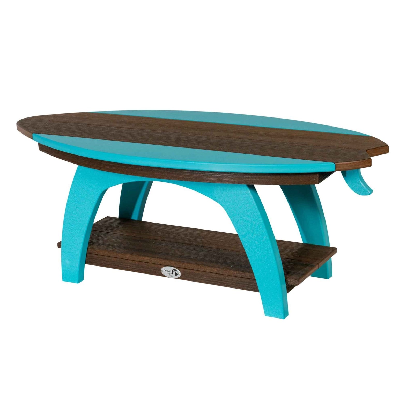 Navy and gray surfboard shaped coffee table with a lower shelf and a vase of flowers on the sand