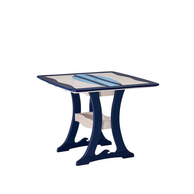 Angled view of a navy and sand poly dining table with light blue surfboard inlay, curved legs and shelf on white