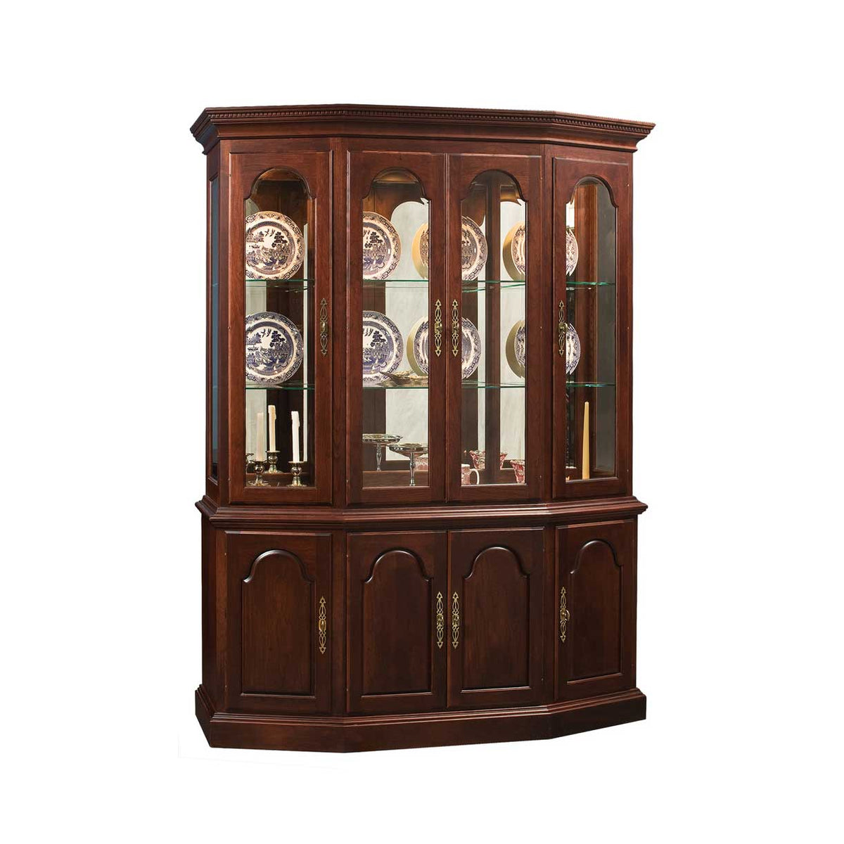 Wooden china cabinet with glass doors displaying decorative plates on a white background