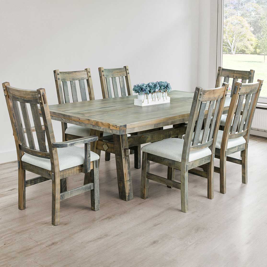 Gray toned dining set with a trestle table, four side chairs and two arm chairs with cream fabric seats