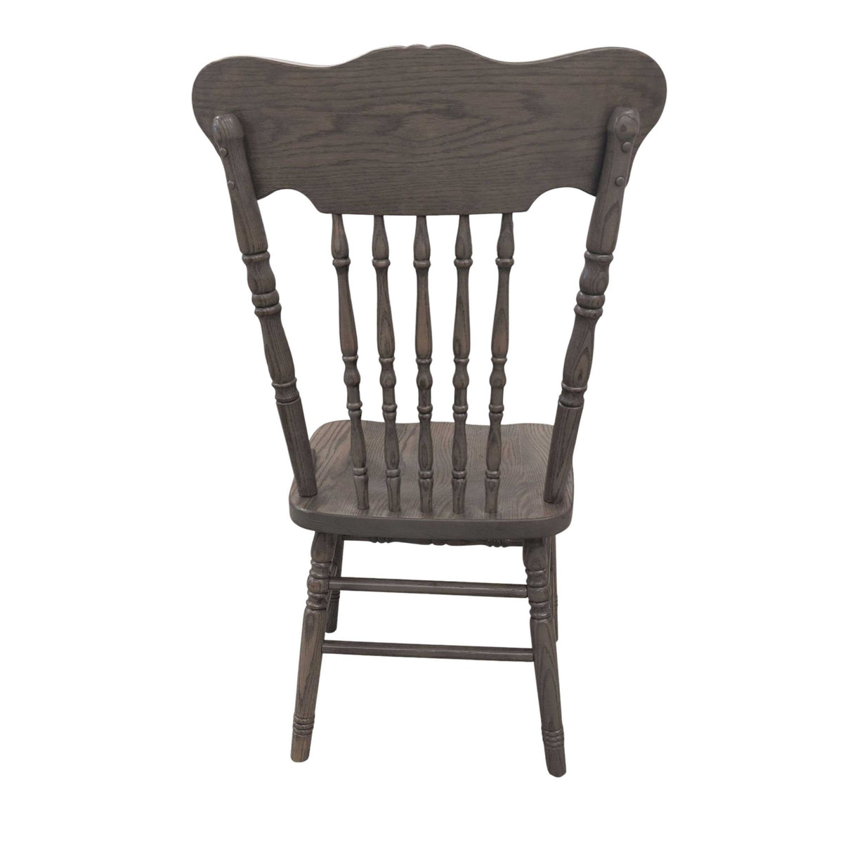 Back view of a gray washed pressback chair showing the shaped crest, six turned spindles and stretcher base