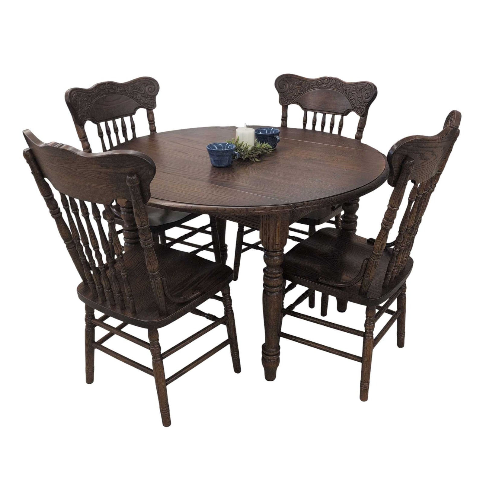 Round oak dining set with four pressback chairs in a dark walnut stain shown on a furniture showroom floor