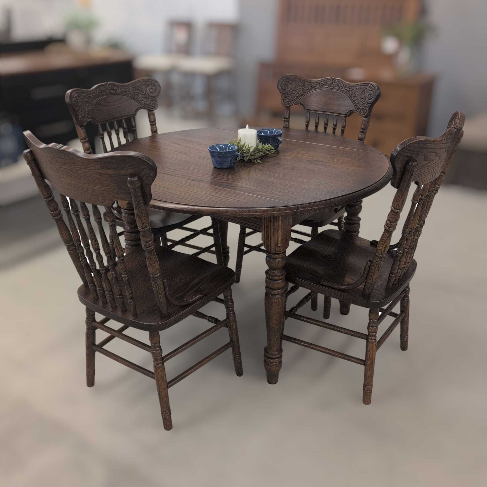 Round oak dining set with four pressback chairs in a dark walnut stain shown on a furniture showroom floor