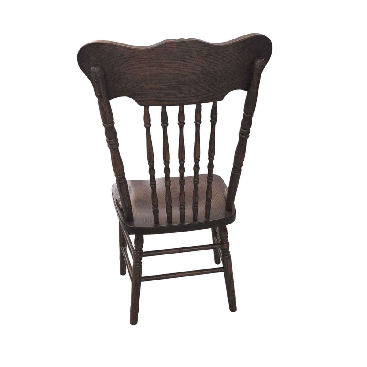Rear view of a dark stained pressback dining chair with turned spindles, saddle seat and turned legs