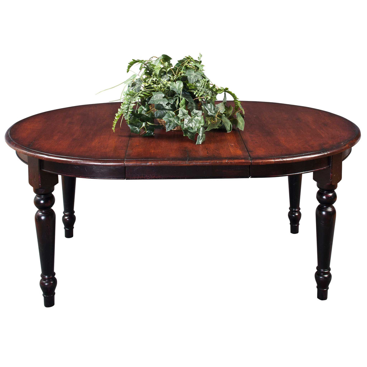 Oval extension dining table with a cherry stained top, center leaf and chunky black turned legs