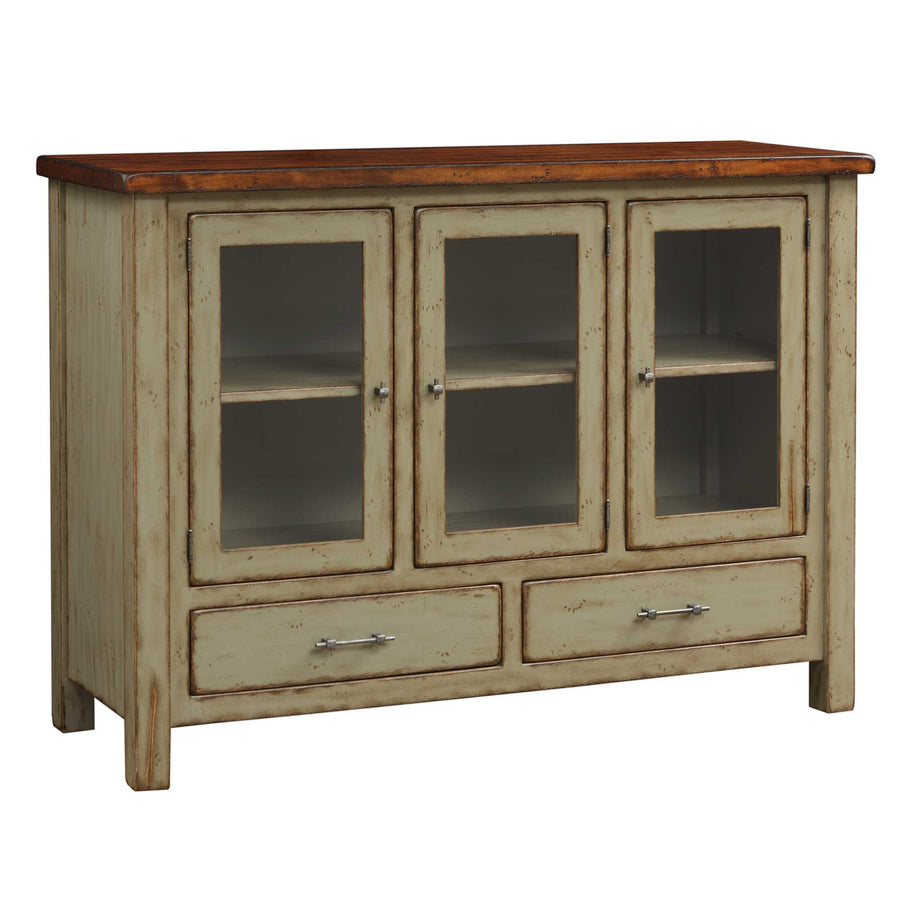 Distressed sage green dining sideboard with a butcher block top, three glass display doors and two drawers with nickel bar pulls