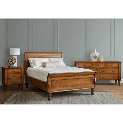 Cherry sleigh bed with curved headboard and footboard, turned feet, plus matching nightstand and dresser