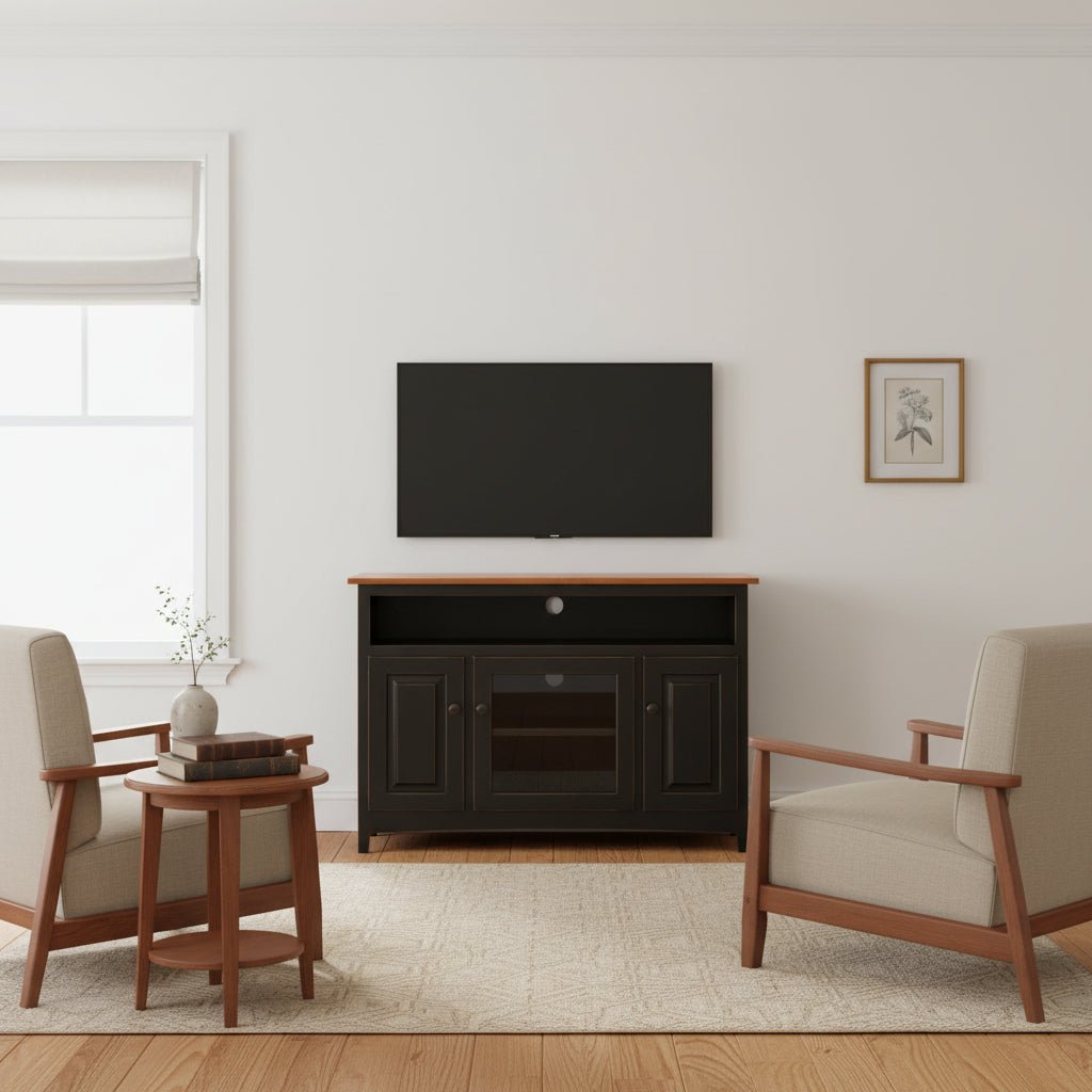 Black painted Shaker TV stand with a wood top, open shelf, two panel doors and a glass center door under a wall mounted TV
