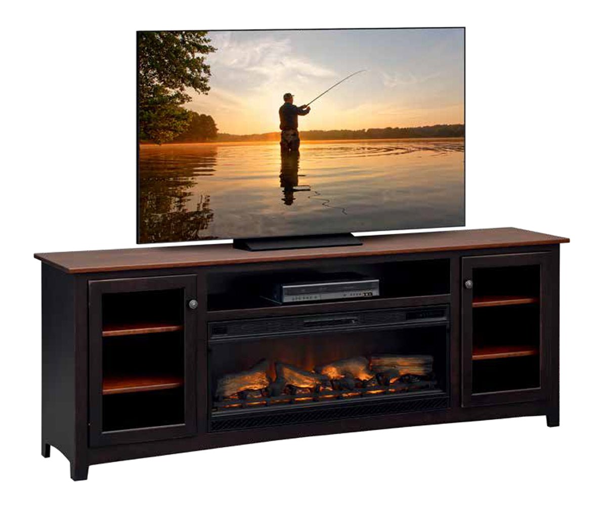 Black TV stand with a wood top and a long electric fireplace flanked by glass doors, on a white shiplap wall
