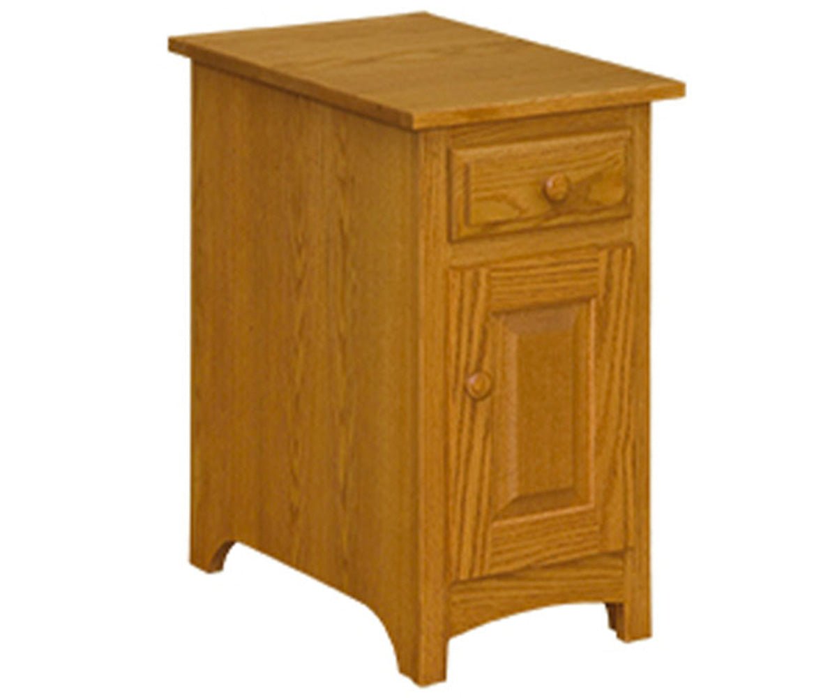 Narrow oak chairside table with a small drawer over a raised panel door, wood knobs and a curved apron