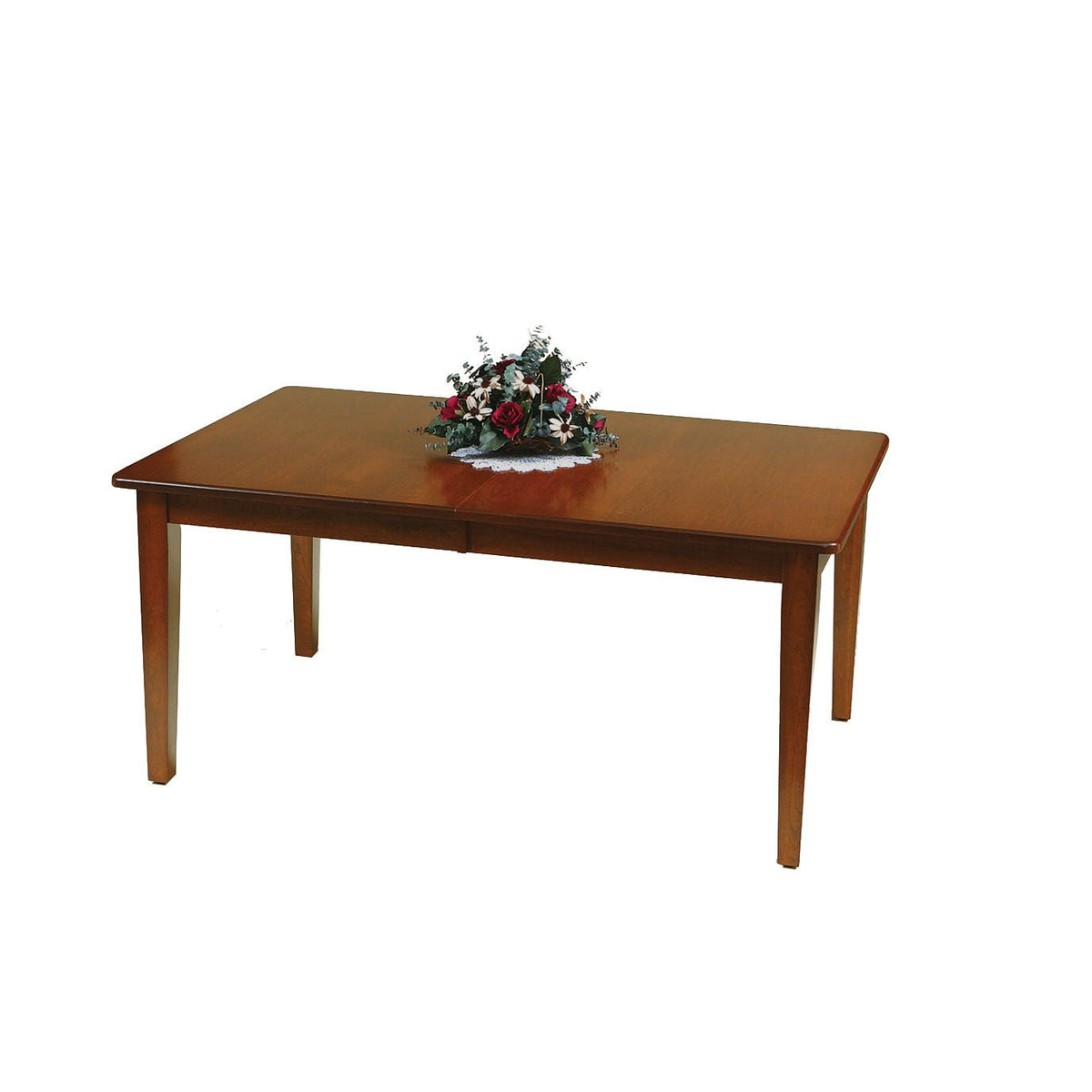 Cherry finished extendable dining table with a center leaf seam and tapered legs, holding a silk floral arrangement