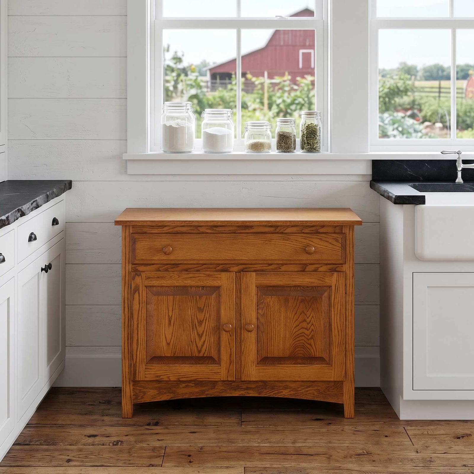 A rustic wooden kitchen cabinet with a single drawer and two paneled doors, set against a white shiplap wall in a farmhouse kitchen.