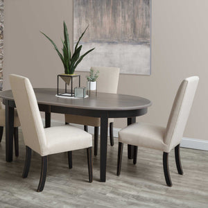 Cream upholstered parsons dining chairs with black tapered legs around an oval gray topped dining table in a modern dining room