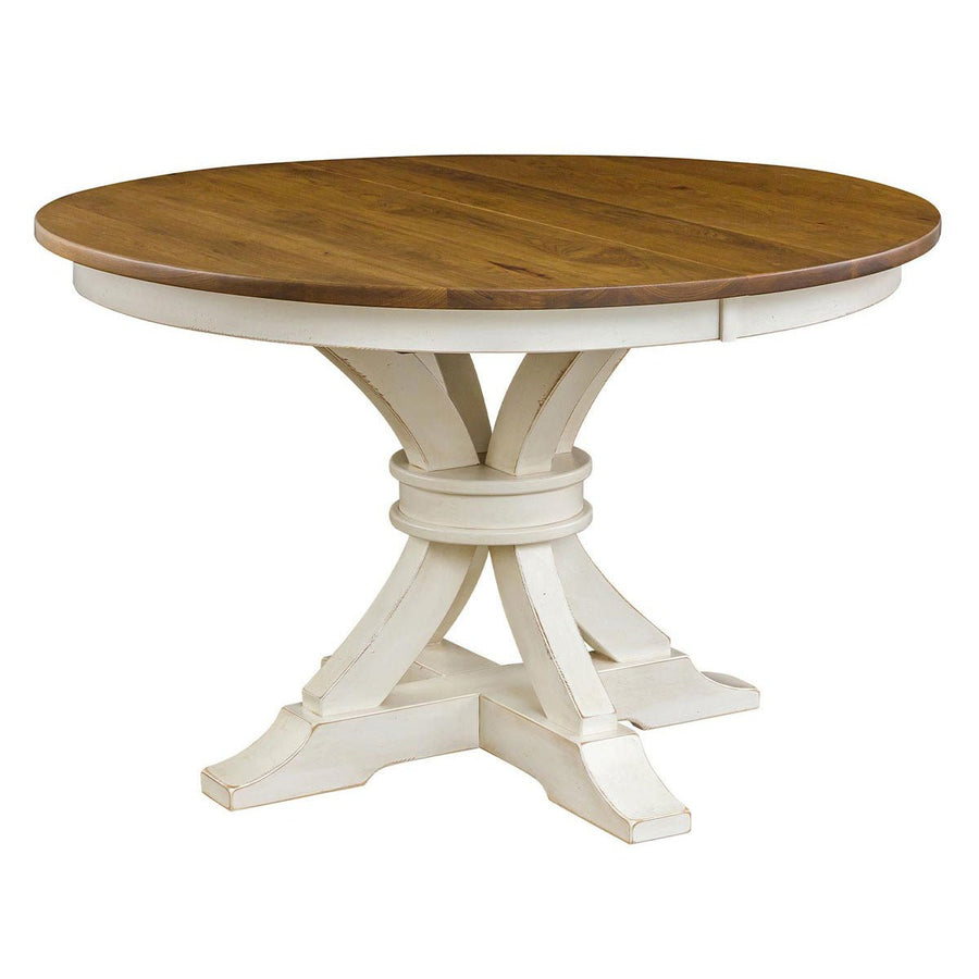 Round pedestal dining table with a honey oak top and curved antique white painted pedestal base on a white background