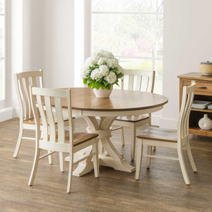 Round expandable pedestal table with an oak top and antique white base set with four painted chairs and white hydrangeas