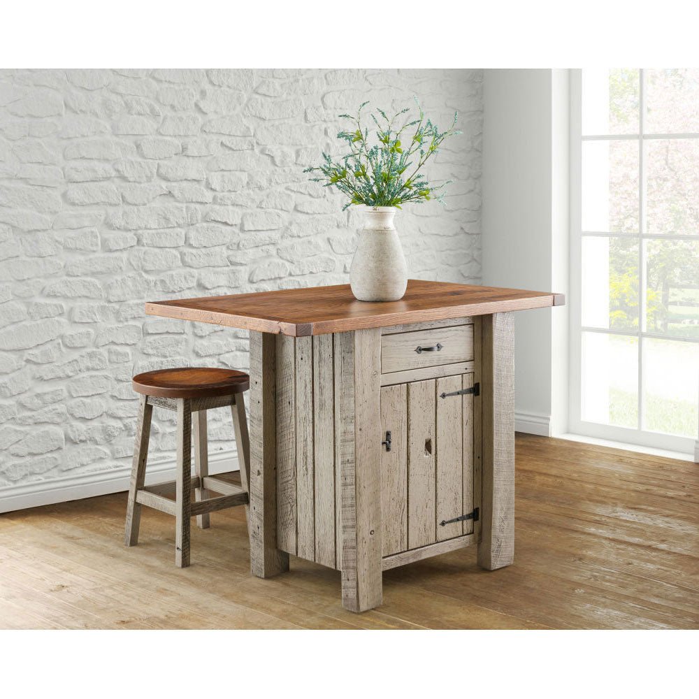 Compact reclaimed wood kitchen island with an oak top and one round stool, staged against a white stone wall