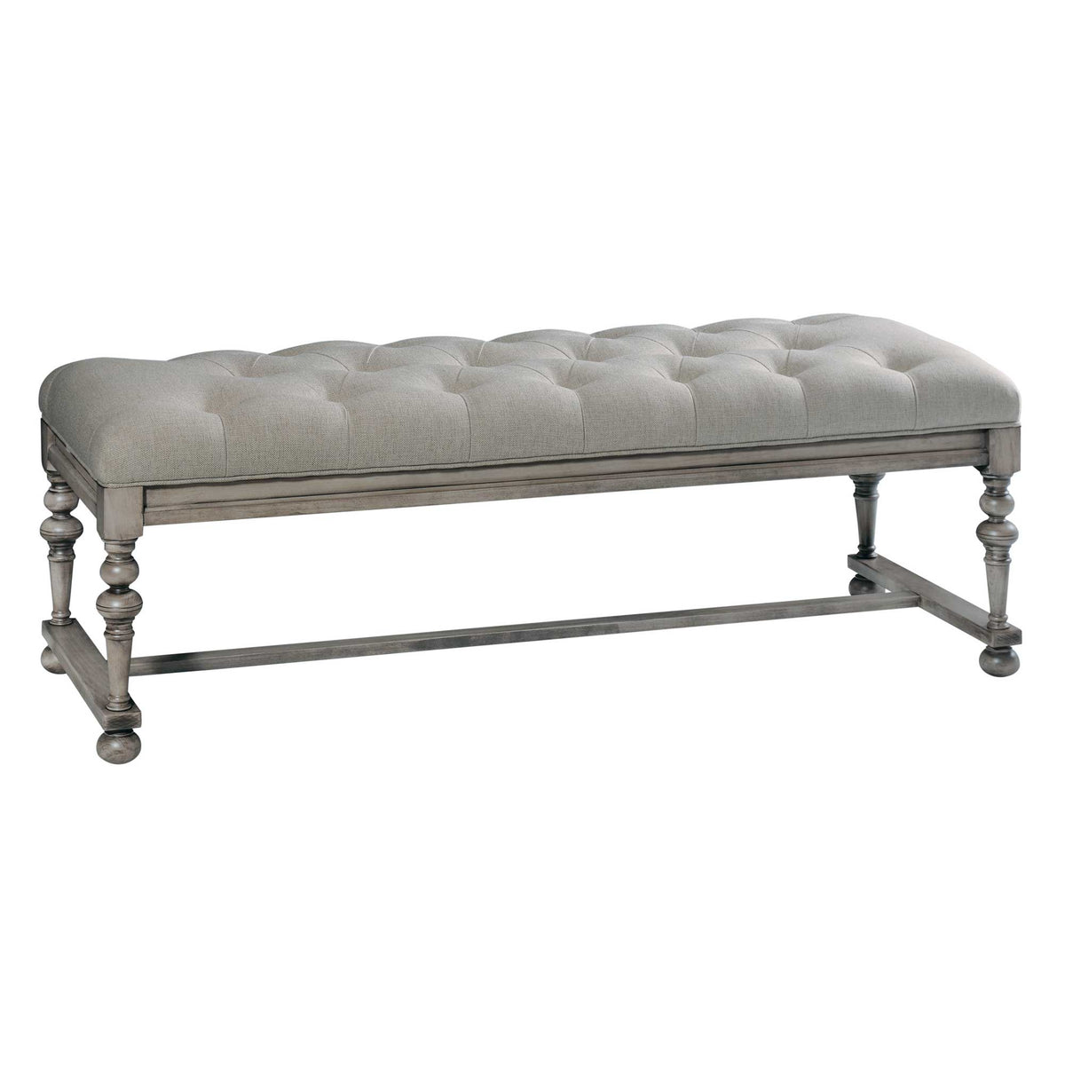Gray washed bedroom bench with button-tufted linen cushion, turned legs, ball feet and H stretcher on white