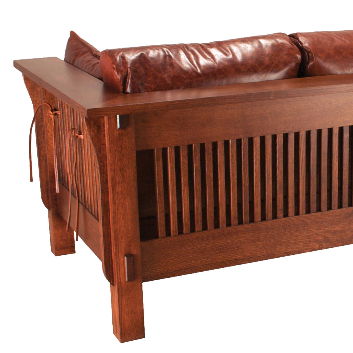 Detail of the Mission sofa back showing quartersawn oak spindles, exposed peg joinery and leather lacing ties