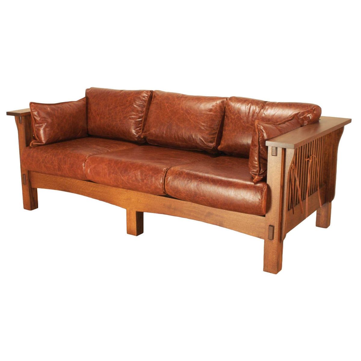Mission sofa in quartersawn oak with three saddle brown leather seat cushions, wide flat arms and spindle sides