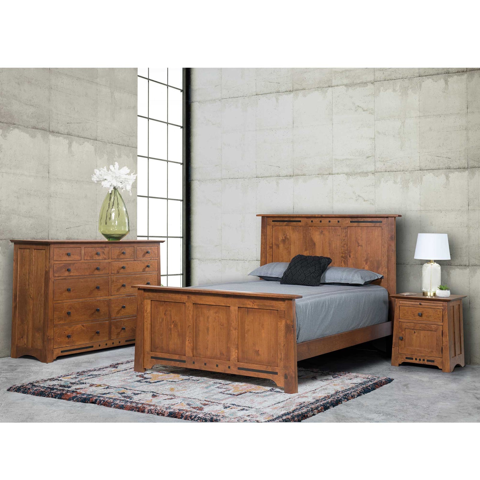 Van Nuys panel bedroom set in cherry with a queen panel bed, twelve-drawer dresser and door nightstand in a loft-style room