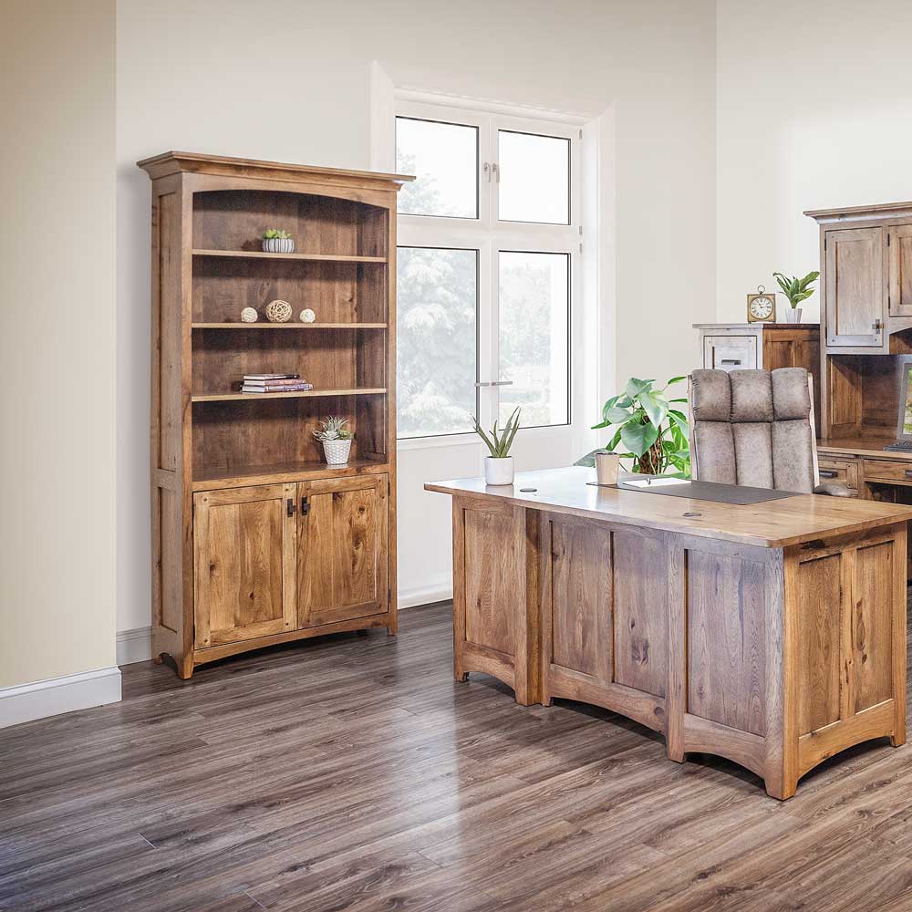 Rustic hickory bookcase with four open shelves over two paneled doors, beside an executive desk by a window
