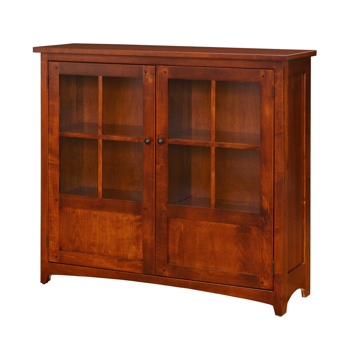 Cherry bookcase with two glass paned doors over paneled bottoms and interior shelves, on a white background