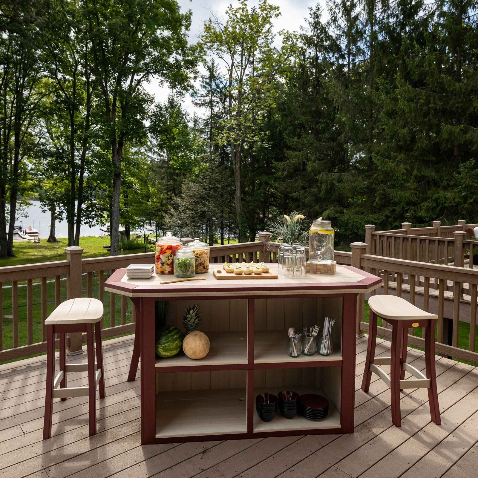 Birch and cherrywood poly bar island with six saddle-seat counter stools arranged on a wooden deck