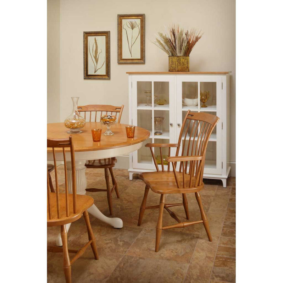 Cherry thumb back Windsor chairs with bamboo turned spindles around an oval table with a white painted pedestal