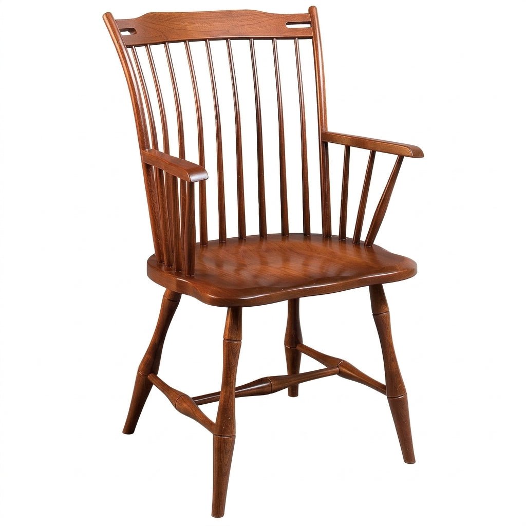 A classic wooden spindle-back dining chair with a warm medium-brown finish, featuring a high back, vertical slats, and armrests, shown against a plain white background.