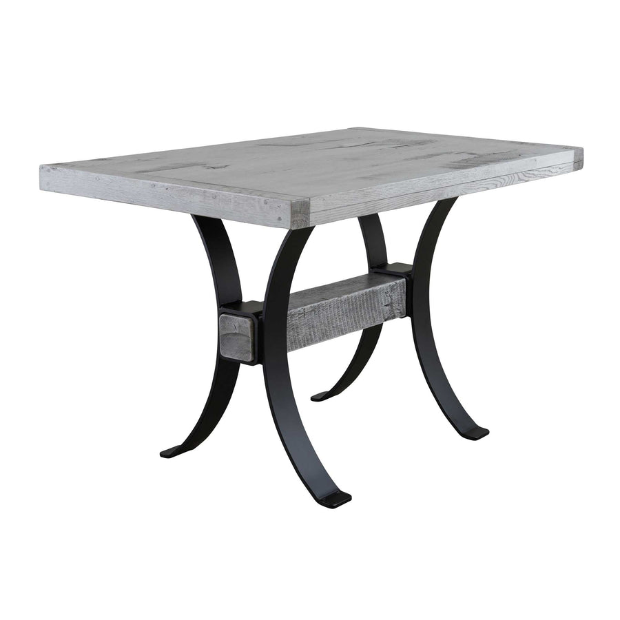 Counter height pub table in weathered gray reclaimed wood with a thick plank top and curved black steel legs on white