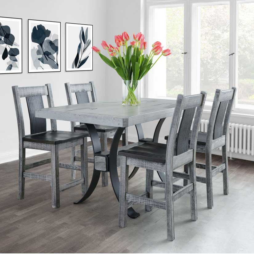 Gray weathered counter height pub table with a black arched metal base and four matching stools in a bright dining room