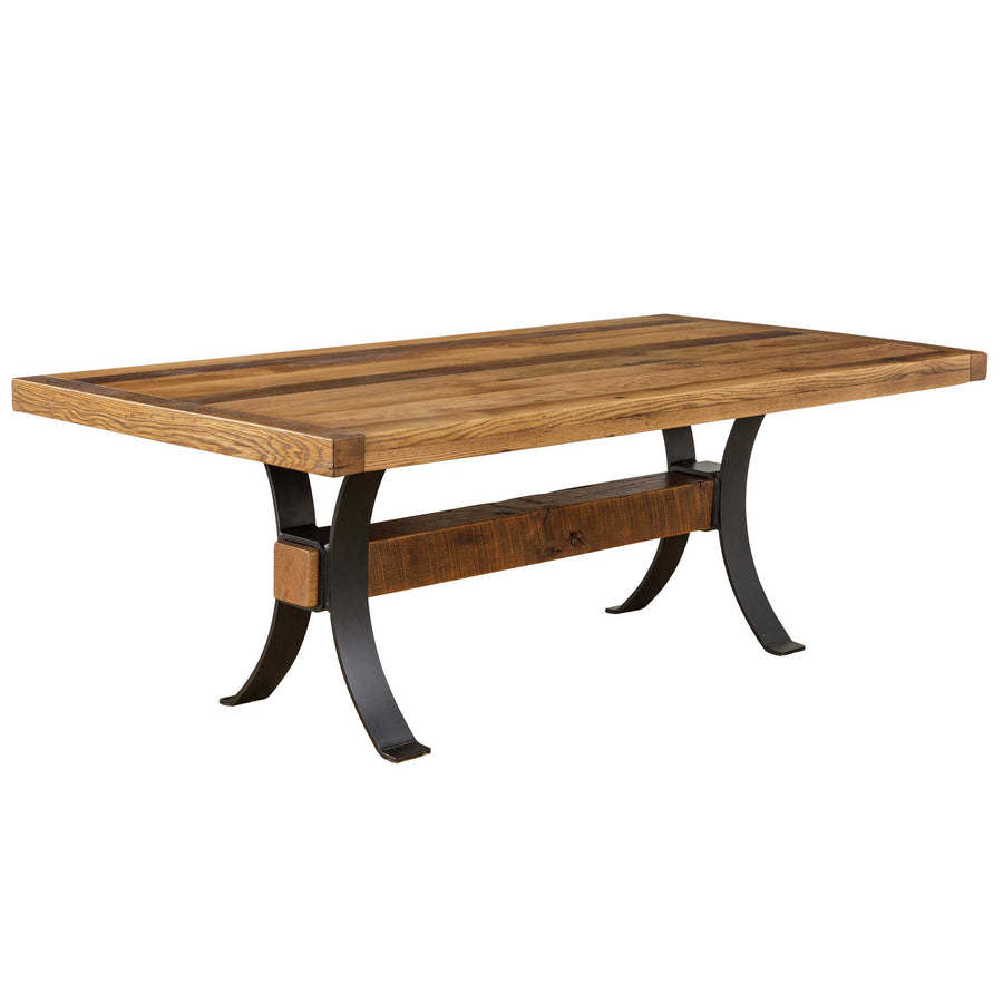 Reclaimed wood farm dining table with a light multi-tone plank top, arched black metal legs and pegged center beam