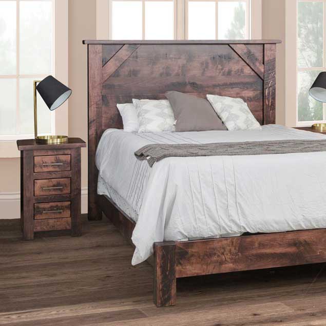 Rustic brown panel bed with a plank headboard and a matching three-drawer nightstand holding a black table lamp