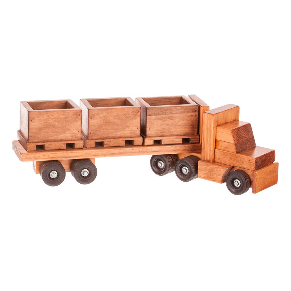 Wooden toy semi truck with a skid trailer carrying three open wooden crates on pallets, on eight dark wheels