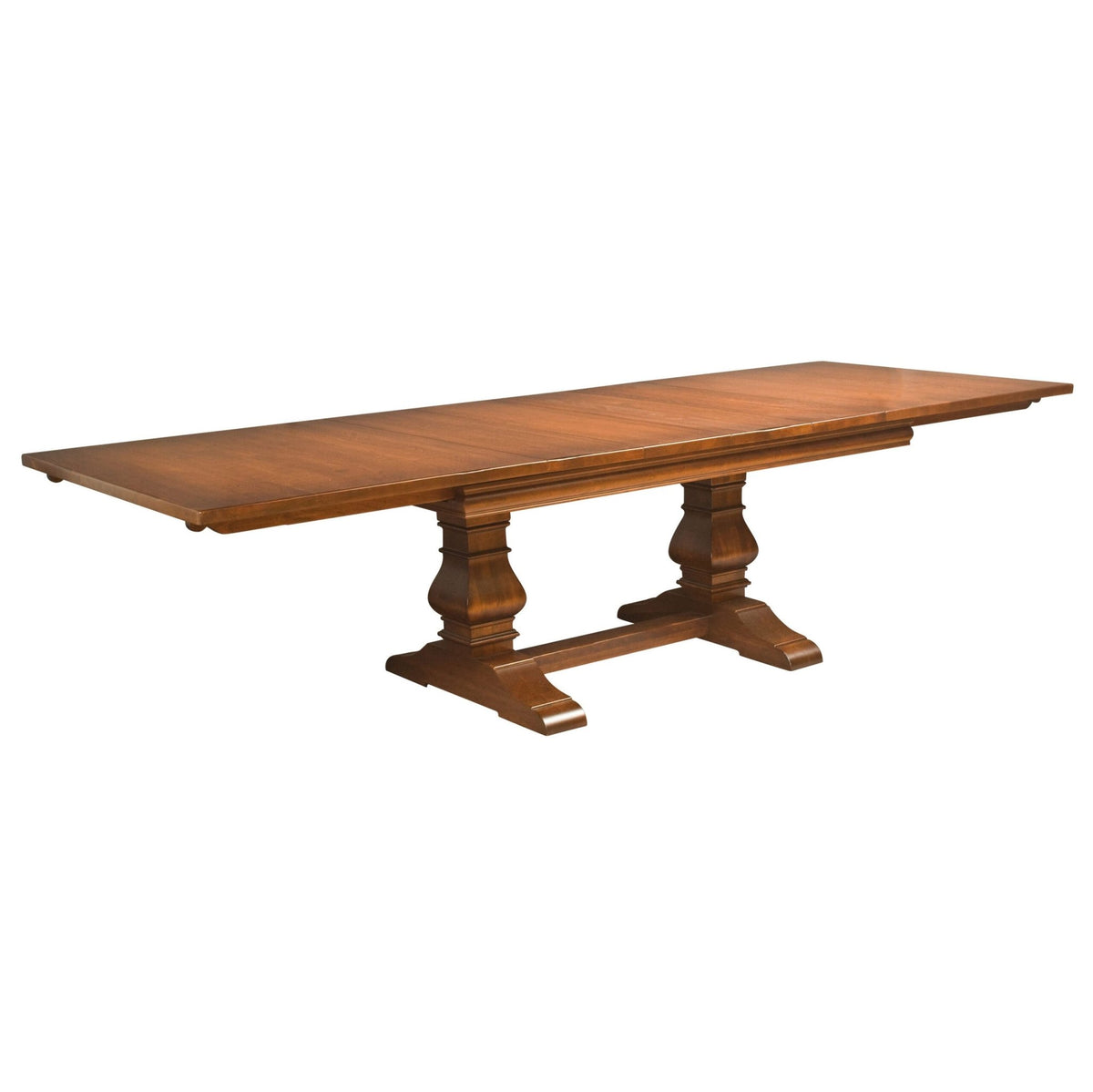 Trestle dining table fully extended with leaves in place, showing the long plank top and twin pedestal base