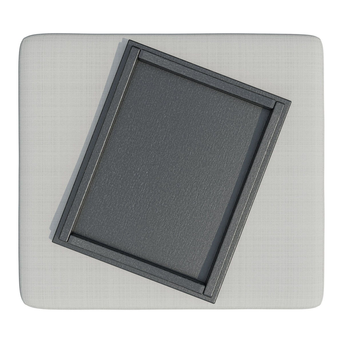 Overhead view of the ottoman's light gray cushion with the black poly serving tray set at an angle on top